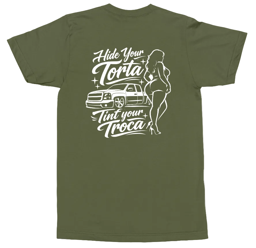 An olive green short-sleeve t-shirt shown from the back, featuring a white graphic print of a car, a pin-up style woman, and the text 'Hide Your Torta, Tint Your Troca'.
