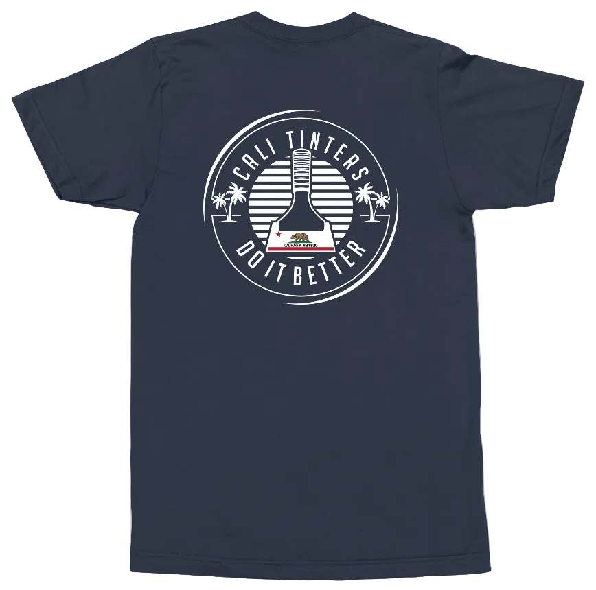 A navy blue short-sleeve t-shirt shown from the back, featuring a large white circular graphic with a tumbler illustration, palm trees, and the text 'CALI TINTERS DO IT BETTER'.