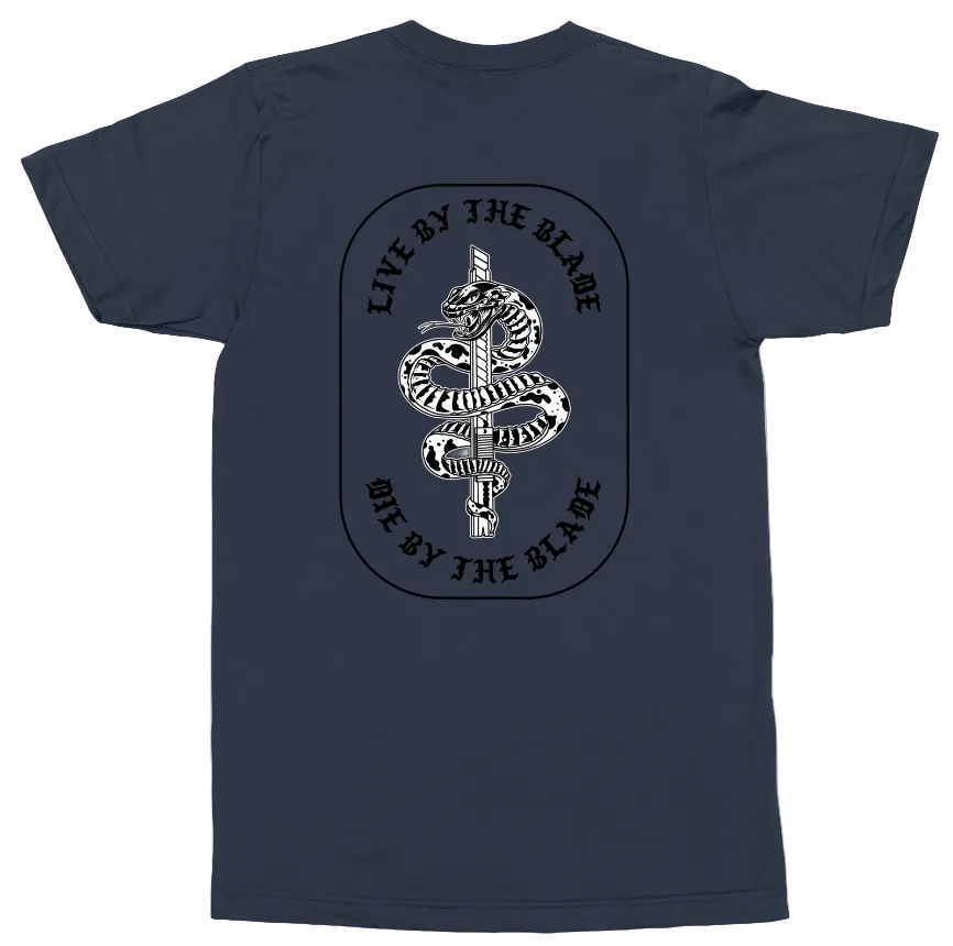 A navy blue short-sleeve t-shirt with a large black and white graphic on the front. The graphic features a snake wrapped around a vertical dagger, enclosed in an oval with the text 'LIVE BY THE BLADE' and 'ONE BY THE BLADE' in a circular font.