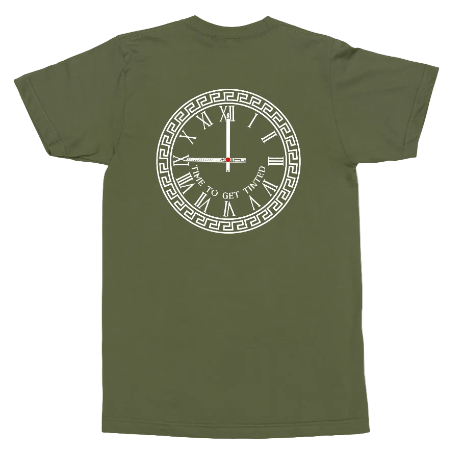 An olive green short-sleeve t-shirt shown from the back, featuring a white graphic of a clock with Roman numerals and Greek key detailing, with the text 'TIME TO GET TWISTED' in the center.