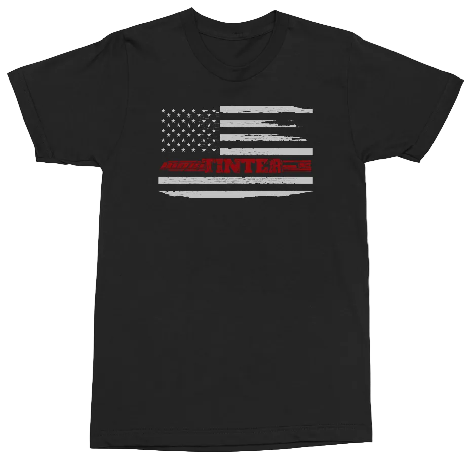 A black short-sleeve crewneck t-shirt featuring a distressed American flag graphic on the chest, with the word 'INTER' printed in red across the stripes.