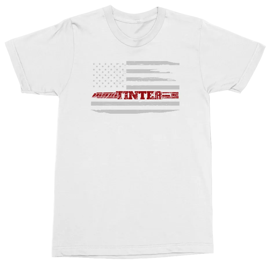 A white short-sleeve crewneck t-shirt featuring a distressed American flag graphic on the chest, with the word 'INTER' in red stylized text across the stripes.