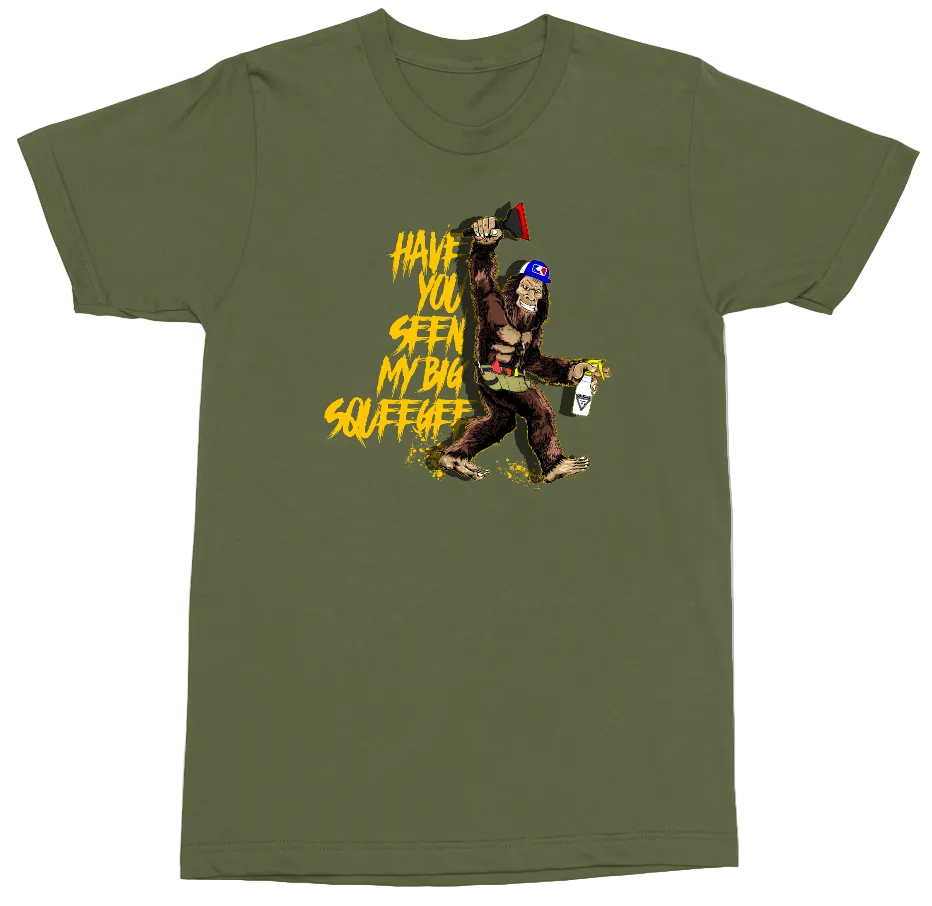 An olive green short-sleeve t-shirt with a graphic print of a Bigfoot character holding a spray paint can next to yellow text that reads 'HAVE YOU SEEN MY BIG SQUEEGEE'.