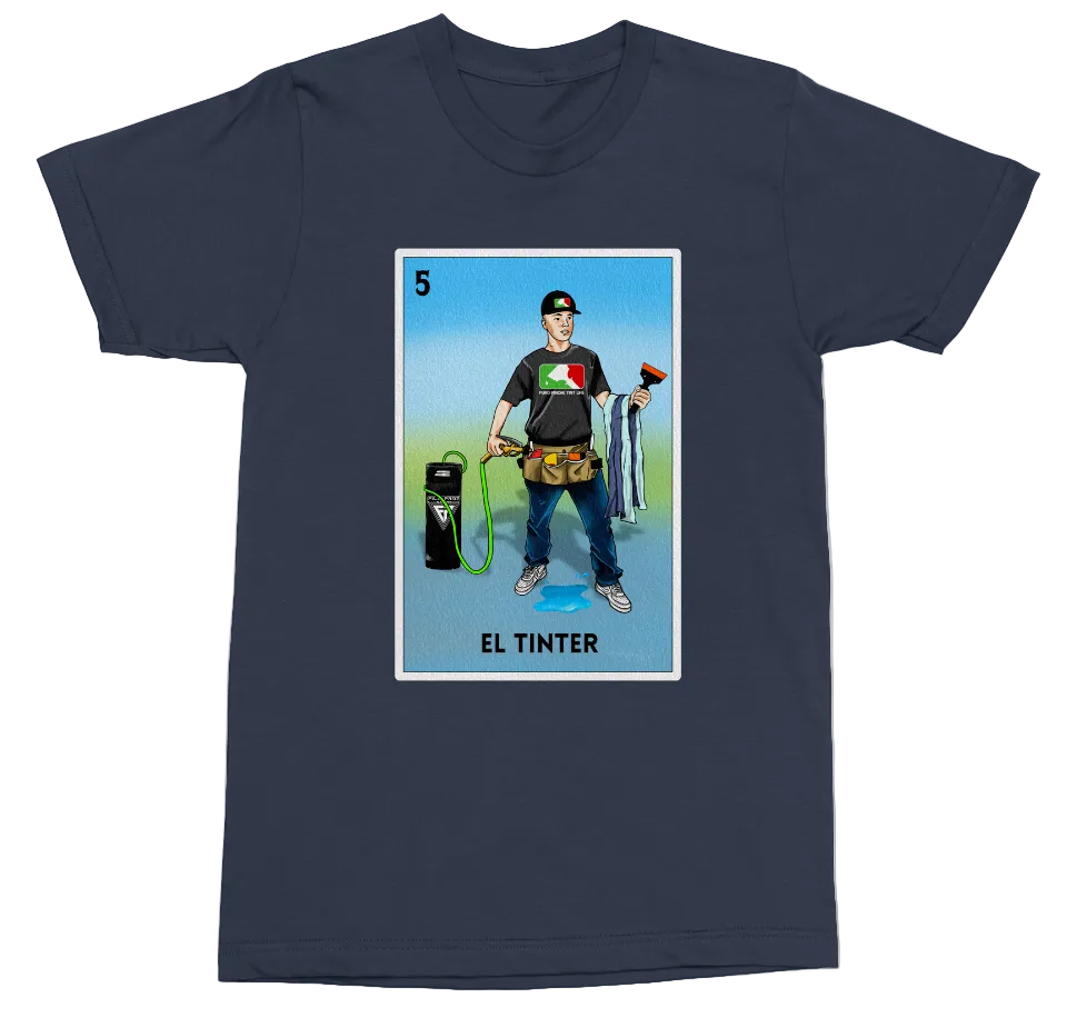 A navy blue short-sleeve crewneck t-shirt featuring a colorful graphic print of a Mexican-style tarot card labeled 'EL TINTER'. The graphic depicts a man in a black t-shirt and jeans holding a spray bottle and a black canister, set against a light blue and green background.