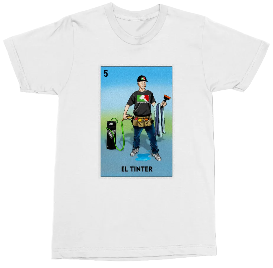 A white short-sleeve crewneck t-shirt featuring a graphic print of a Mexican 'El Tintor' (painter) card. The graphic depicts a man holding a paint can and spray gun with a Mexican flag on his chest, set against a light blue background with the text 'EL TINTOR' at the bottom.