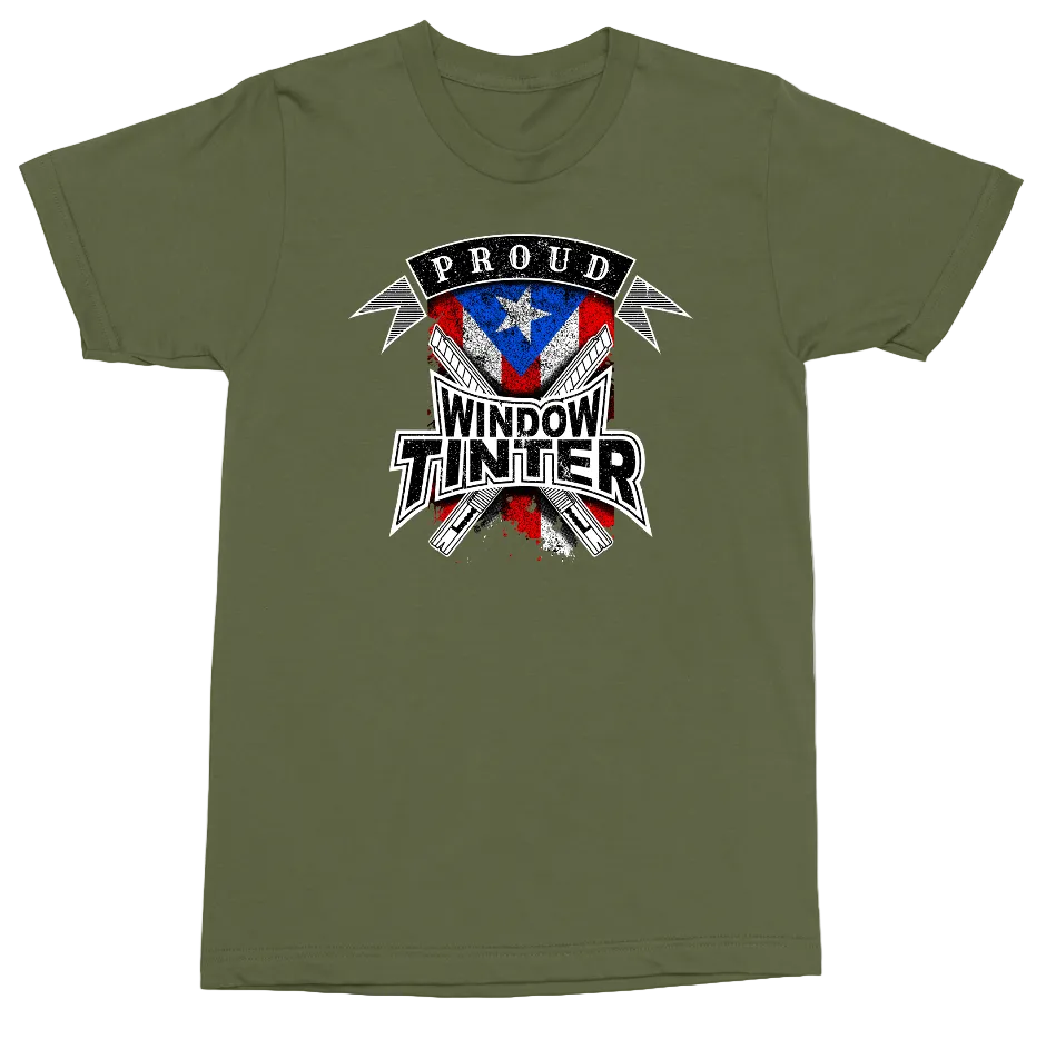 An olive green crewneck t-shirt featuring a distressed patriotic graphic on the chest with the text 'PROUD WINDOW TINTER' and a shield design in red, white, and blue.