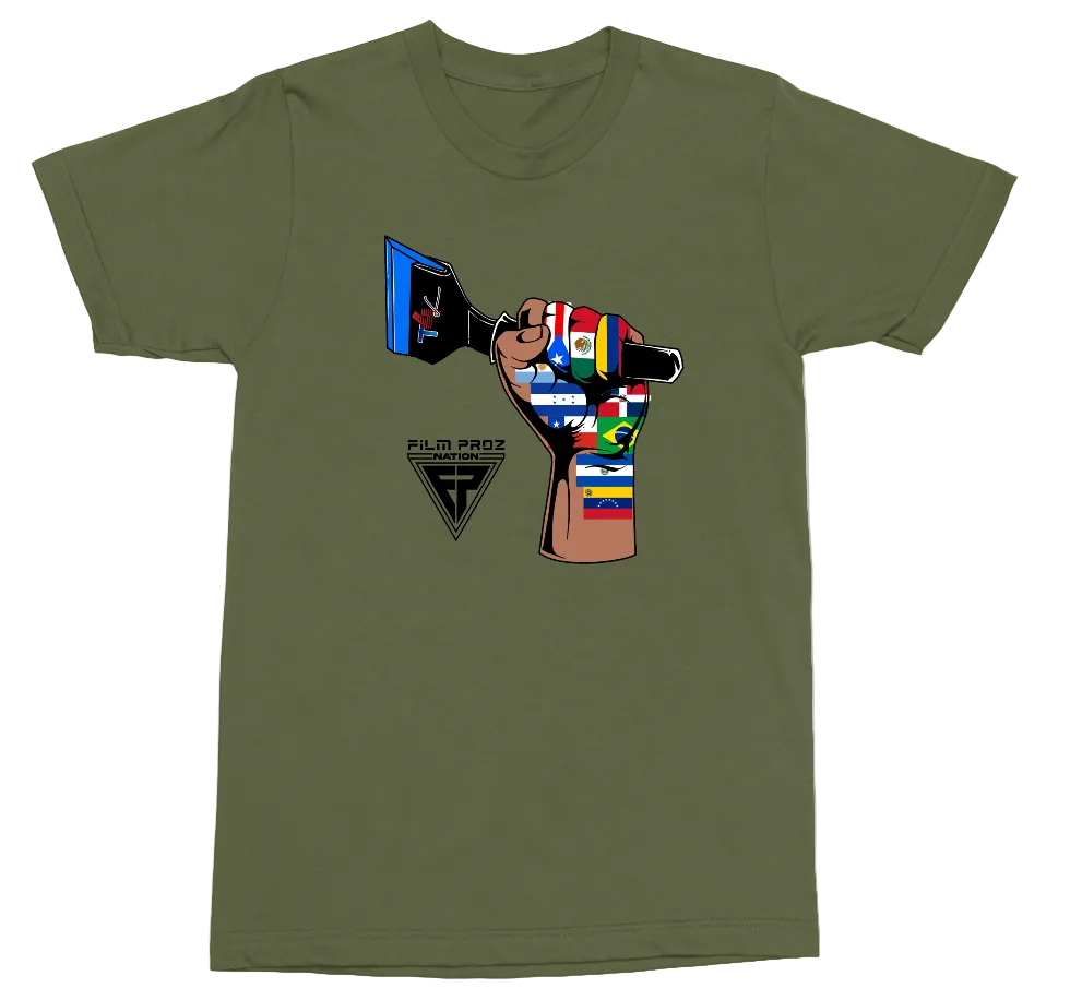 An olive green crewneck t-shirt featuring a graphic of a hand holding a film camera, with the camera body decorated with various national flags. Below the graphic is a black logo that reads 'FILM PROZ INTERNATIONAL'.