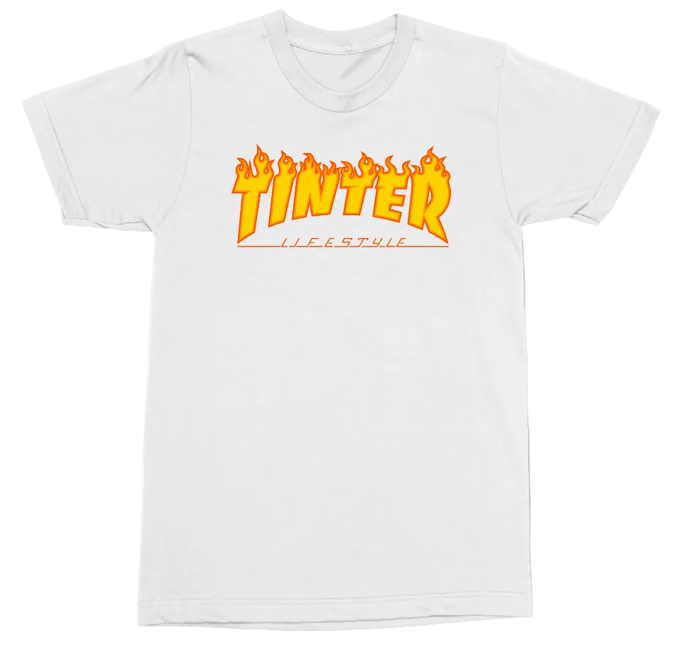 A white short-sleeve crewneck t-shirt featuring a graphic on the chest with the word 'TINTER' in a stylized orange and yellow flame font, and the word 'LIFESTYLE' printed underneath in orange.