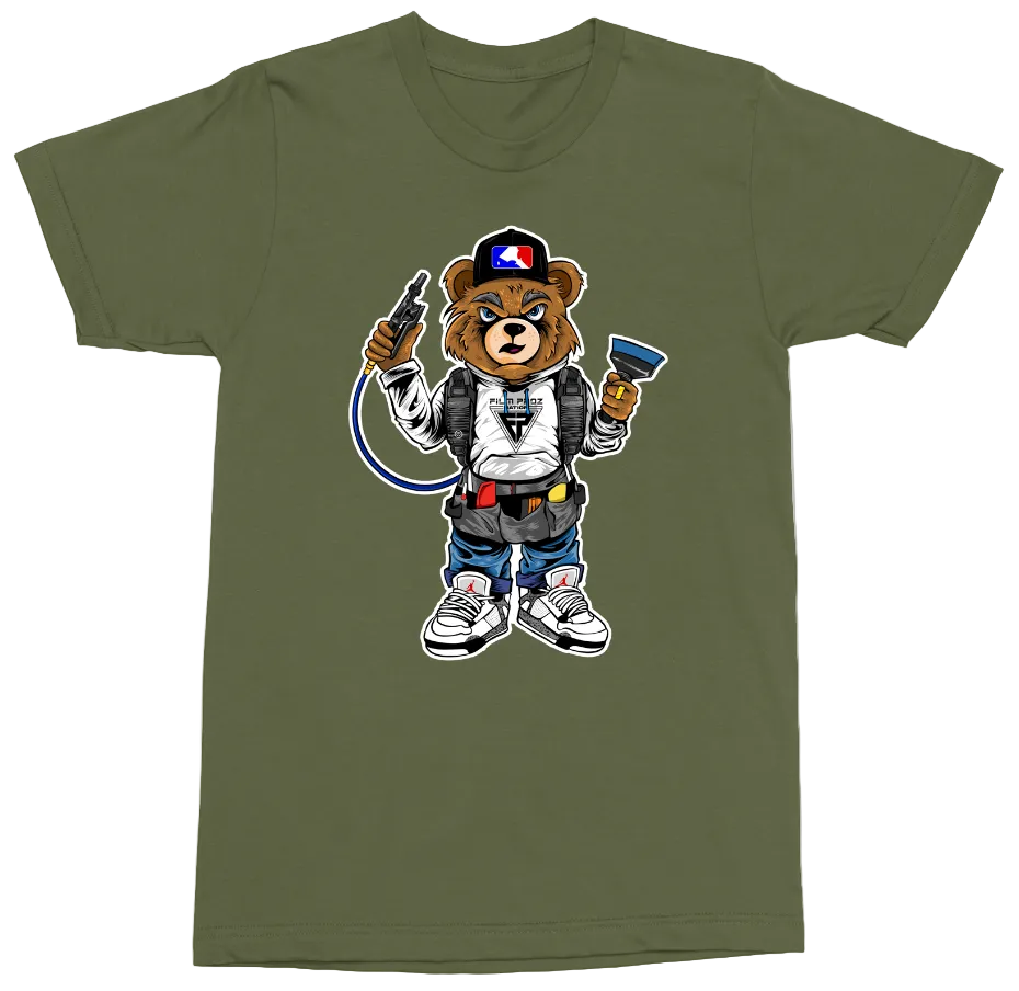 An olive green short-sleeve t-shirt with a cartoon graphic of a bear character dressed in a Ghostbusters-style outfit, holding a wand and a water bottle, on a plain white background.
