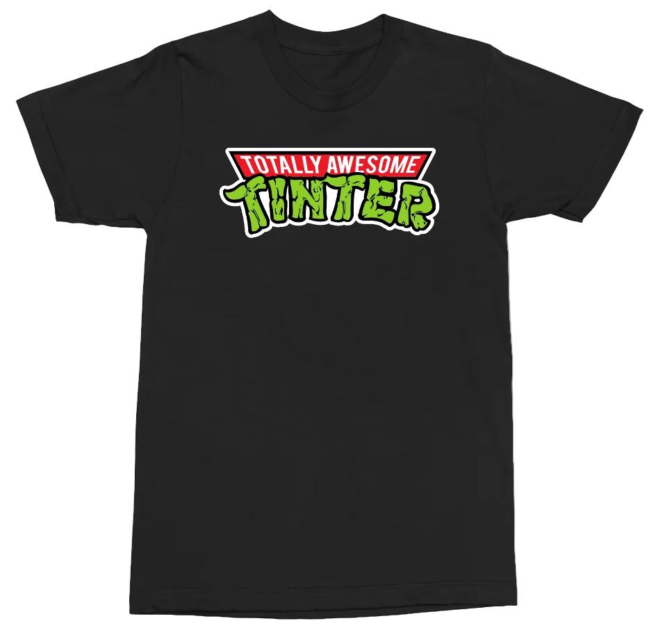 A black short-sleeve crewneck t-shirt featuring a 'Totally Awesome Tintner' graphic on the chest. The graphic has 'TOTALLY AWESOME' in white text inside a red banner, above 'TINTNER' in a green, brush-stroke style font with a white outline.
